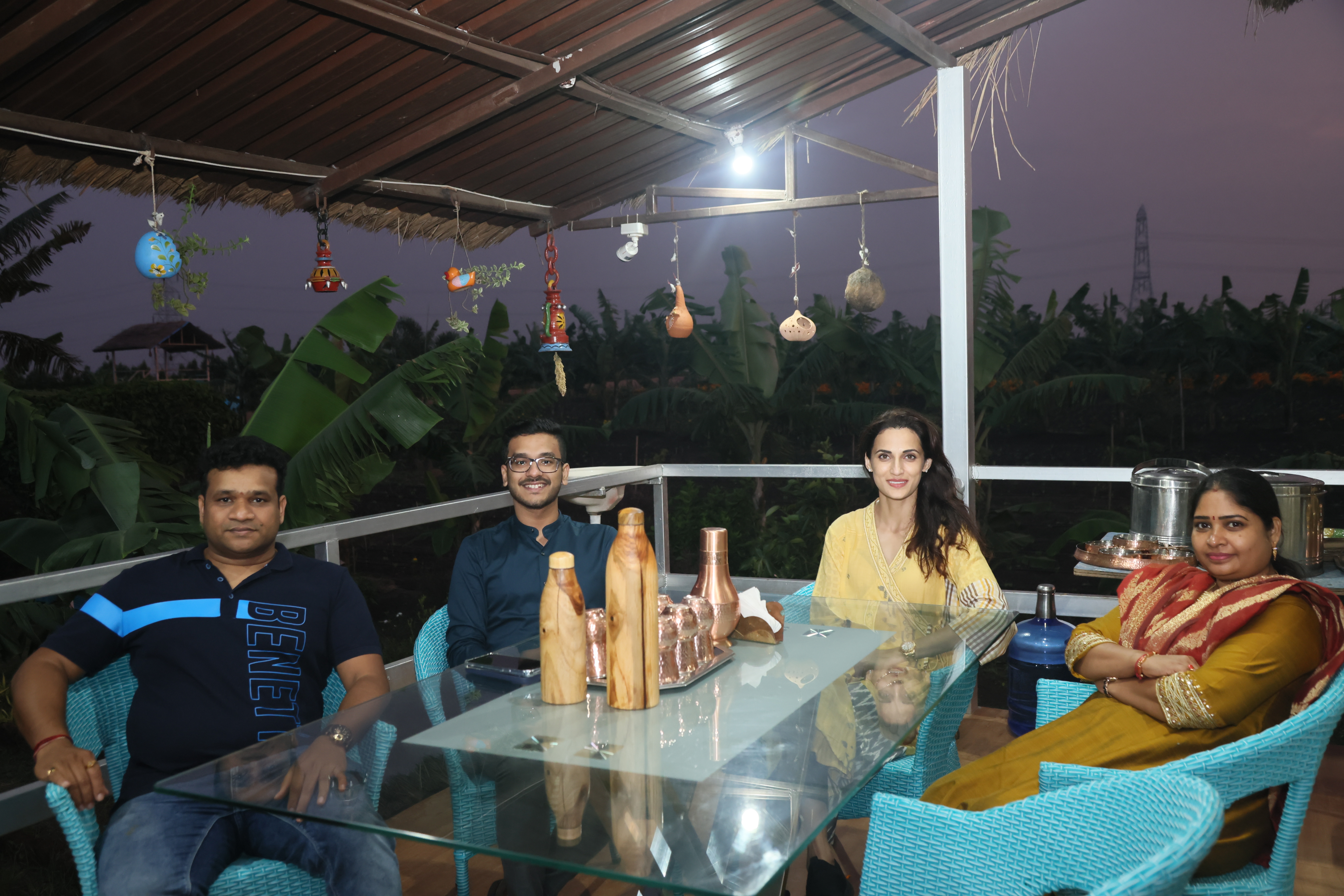 Guests enjoying an evening at an outdoor seating area.